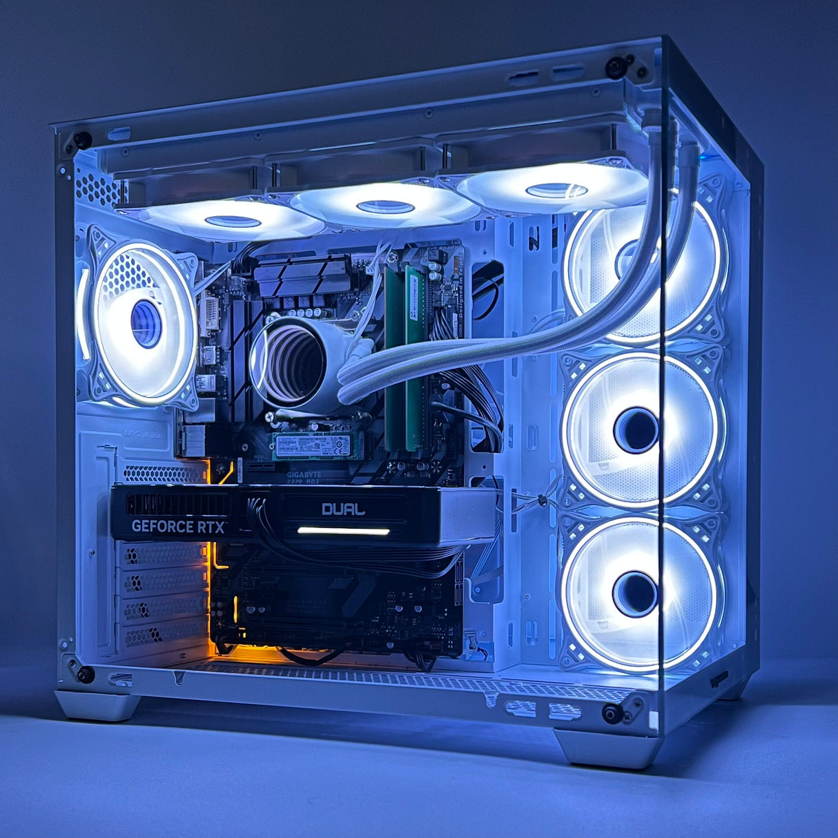 Computer case with transparent side panel showcasing internal components, illuminated by blue LED lights.