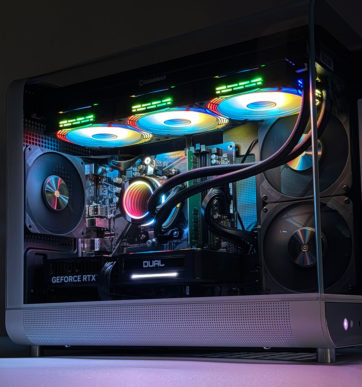 Glossy computer case with colorful lighting and visible components on a dark background